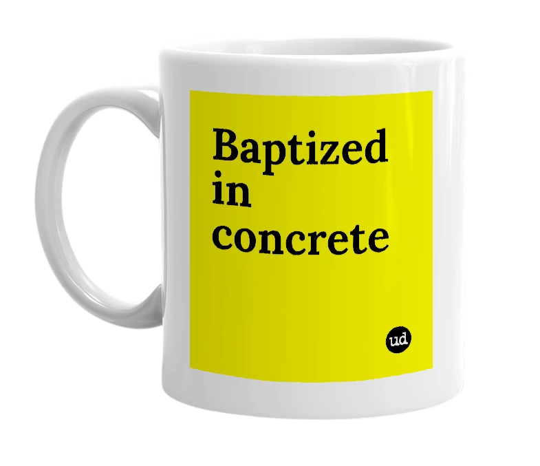 White mug with 'Baptized in concrete' in bold black letters