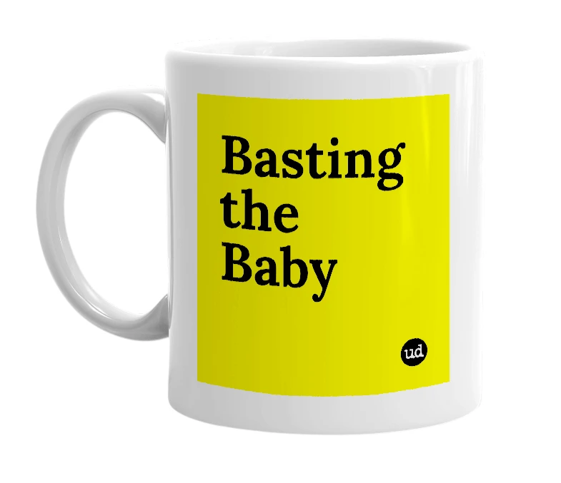 White mug with 'Basting the Baby' in bold black letters