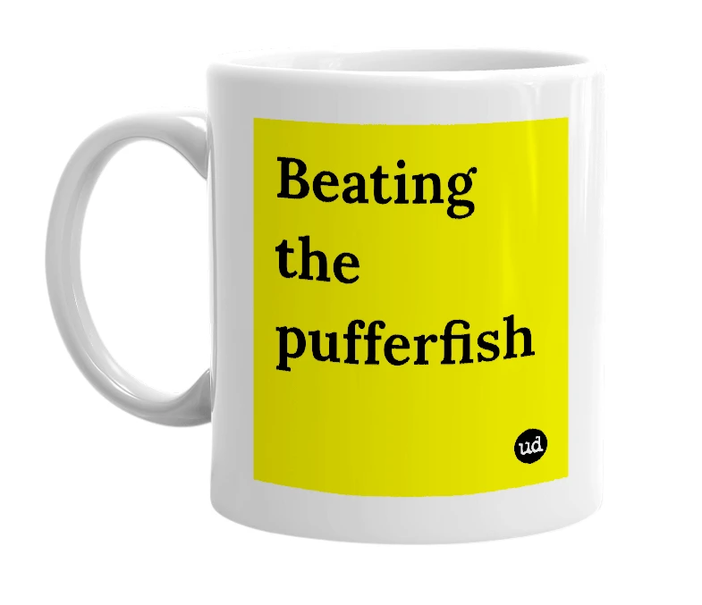 White mug with 'Beating the pufferfish' in bold black letters
