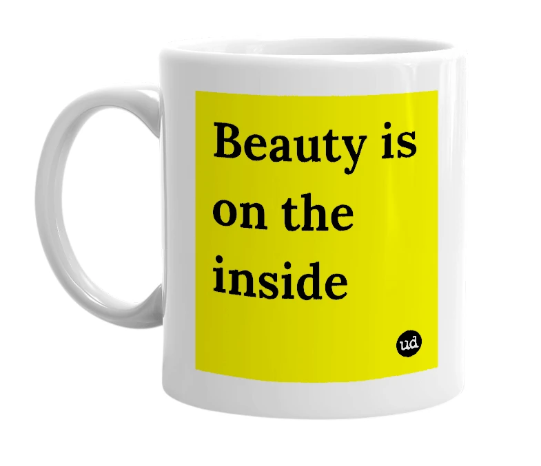 White mug with 'Beauty is on the inside' in bold black letters