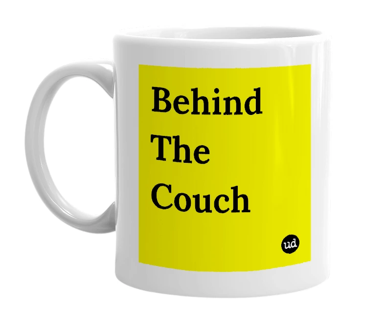 White mug with 'Behind The Couch' in bold black letters