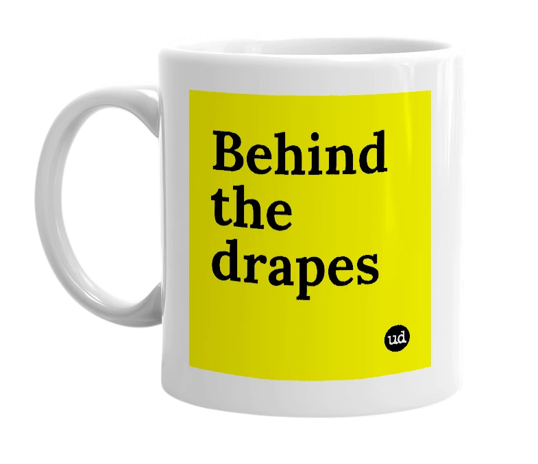 White mug with 'Behind the drapes' in bold black letters
