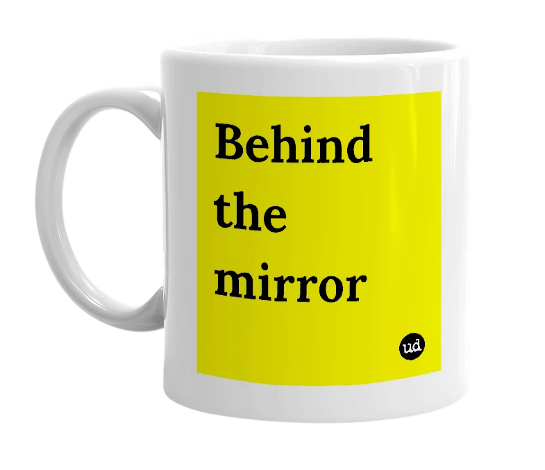 White mug with 'Behind the mirror' in bold black letters