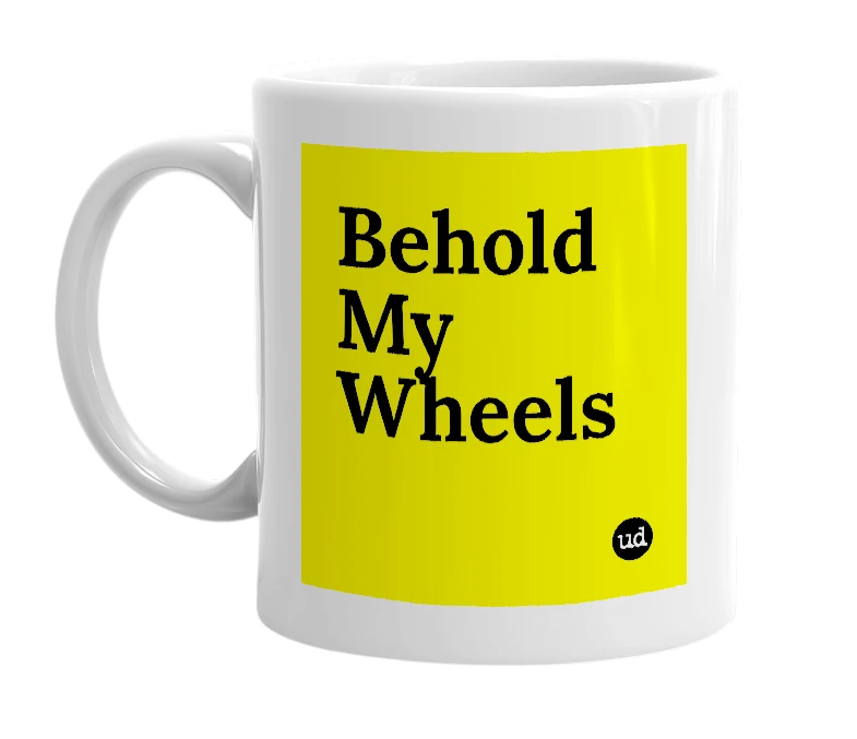White mug with 'Behold My Wheels' in bold black letters