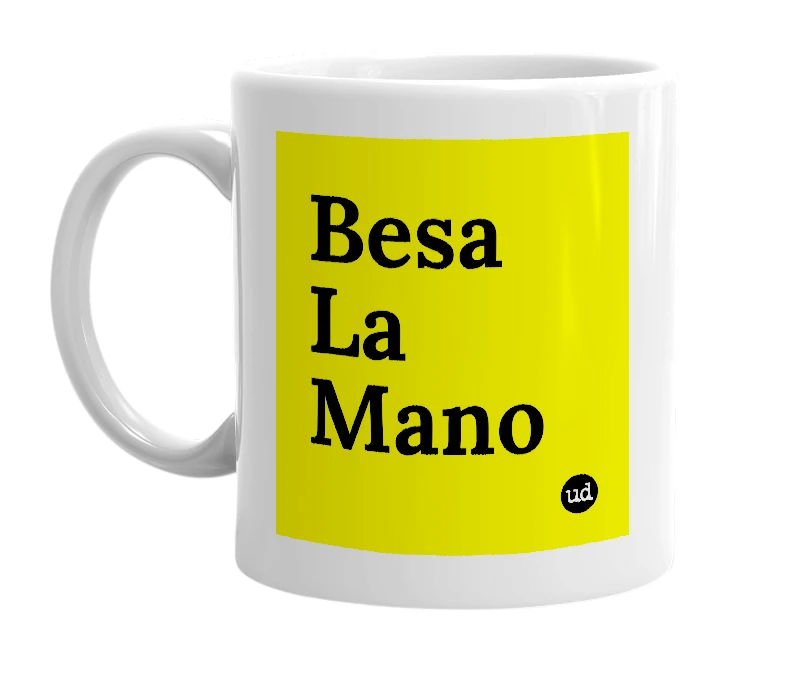 White mug with 'Besa La Mano' in bold black letters