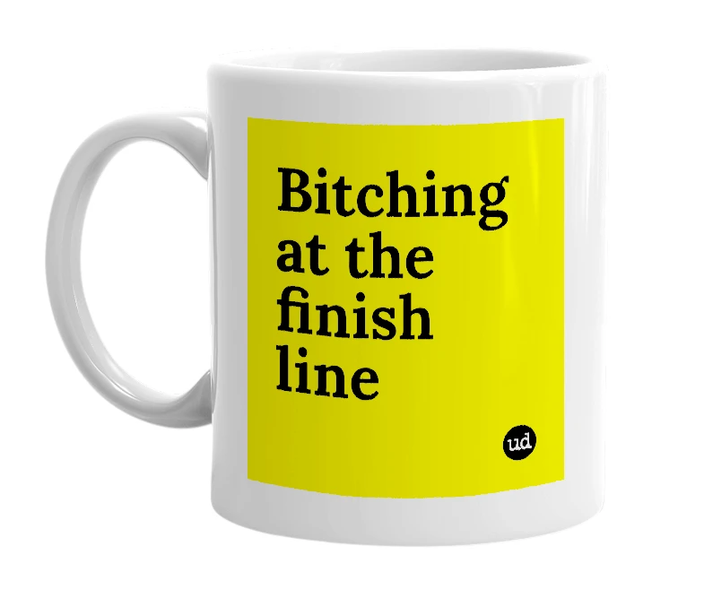 White mug with 'Bitching at the finish line' in bold black letters