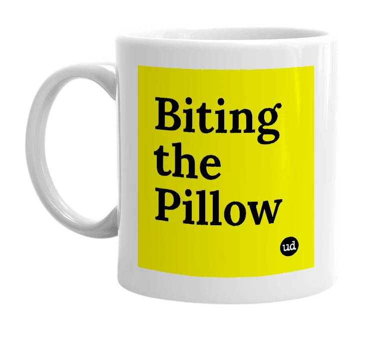 White mug with 'Biting the Pillow' in bold black letters