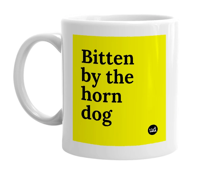 White mug with 'Bitten by the horn dog' in bold black letters