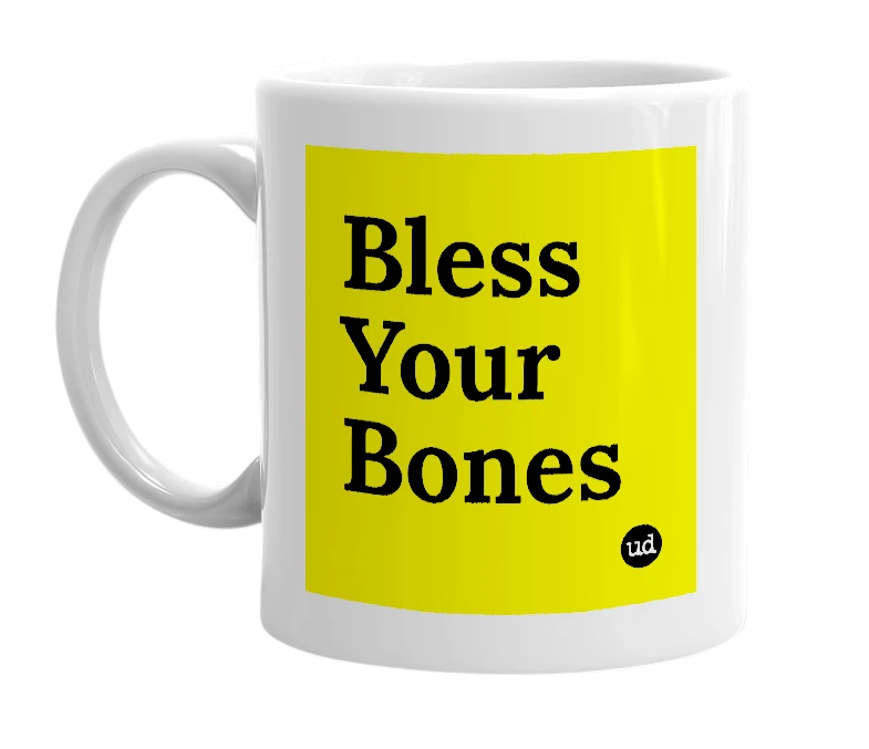 White mug with 'Bless Your Bones' in bold black letters