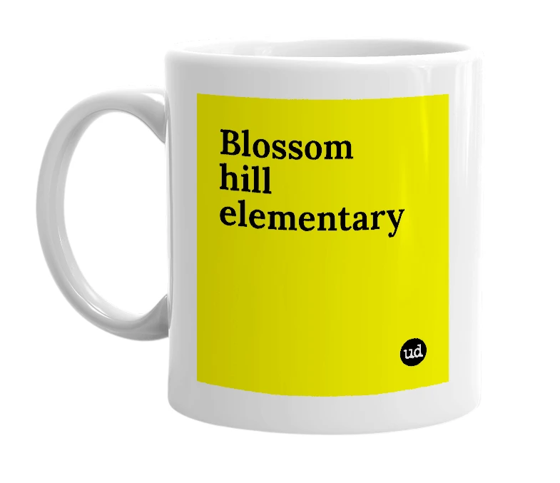 White mug with 'Blossom hill elementary' in bold black letters