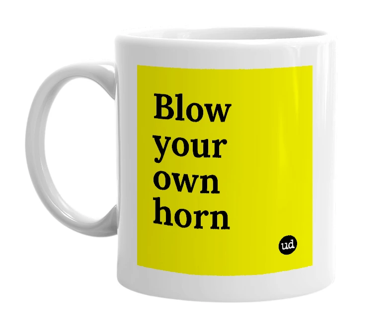 White mug with 'Blow your own horn' in bold black letters