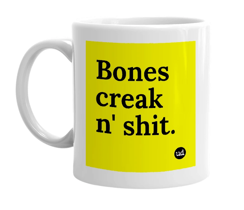 White mug with 'Bones creak n' shit.' in bold black letters
