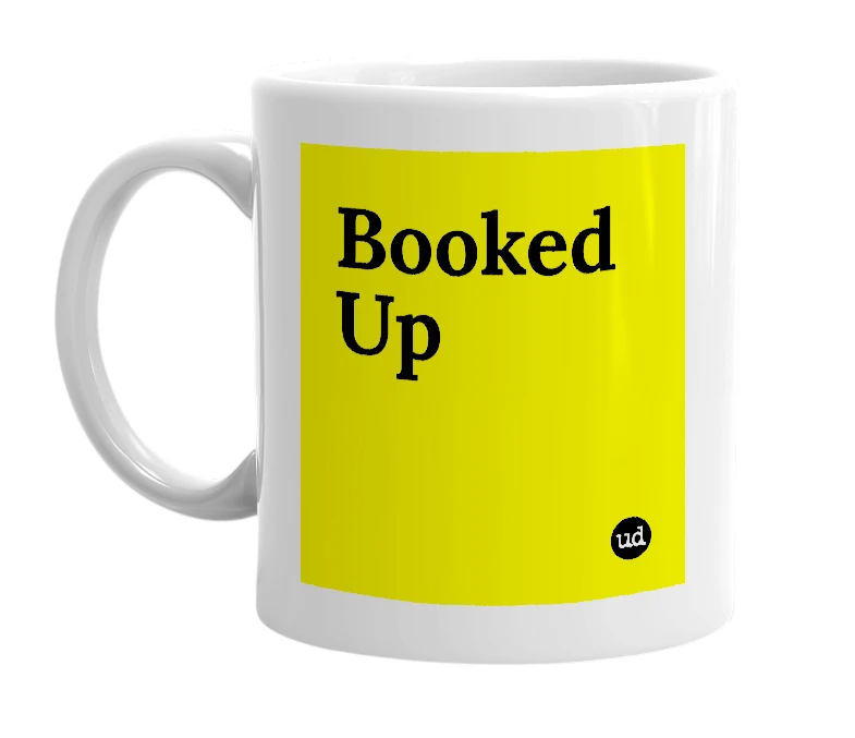 White mug with 'Booked Up' in bold black letters