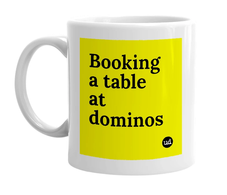 White mug with 'Booking a table at dominos' in bold black letters