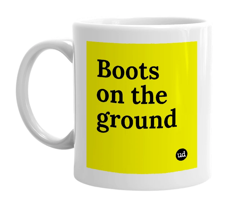 White mug with 'Boots on the ground' in bold black letters