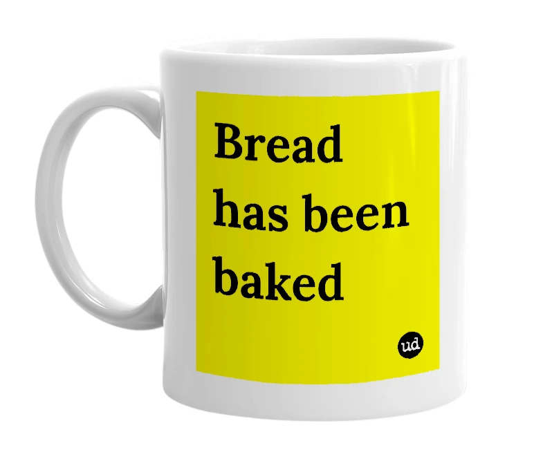White mug with 'Bread has been baked' in bold black letters