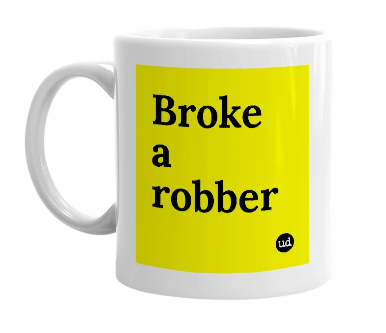 White mug with 'Broke a robber' in bold black letters