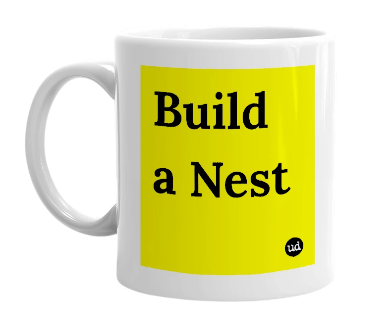 White mug with 'Build a Nest' in bold black letters