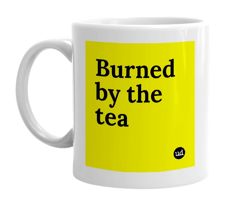 White mug with 'Burned by the tea' in bold black letters