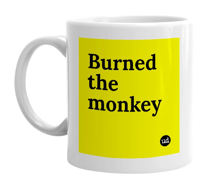 White mug with 'Burned the monkey' in bold black letters