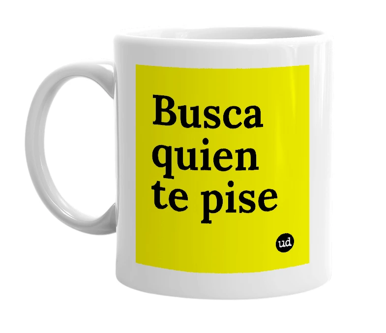 White mug with 'Busca quien te pise' in bold black letters