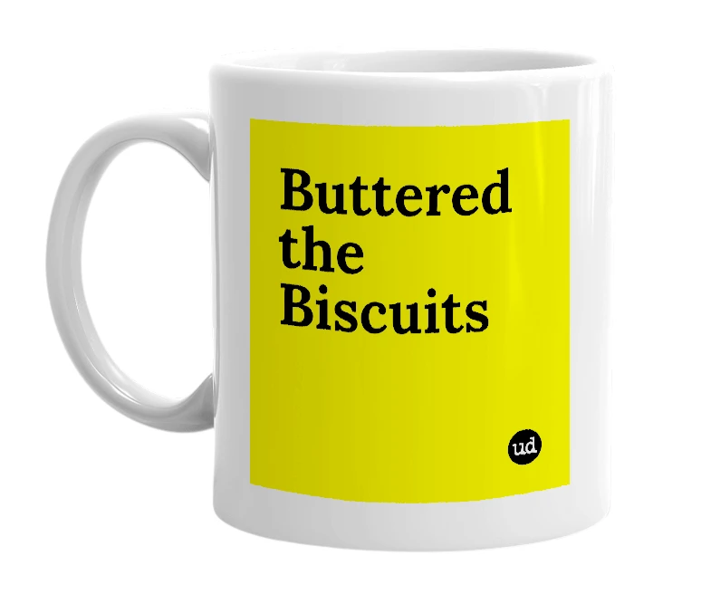 White mug with 'Buttered the Biscuits' in bold black letters