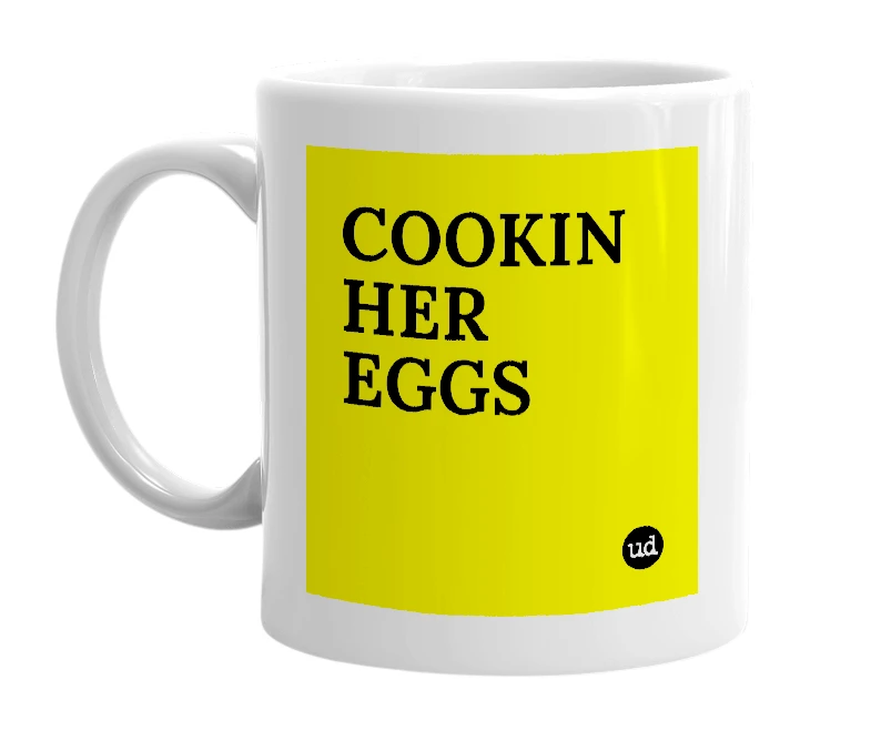 White mug with 'COOKIN HER EGGS' in bold black letters