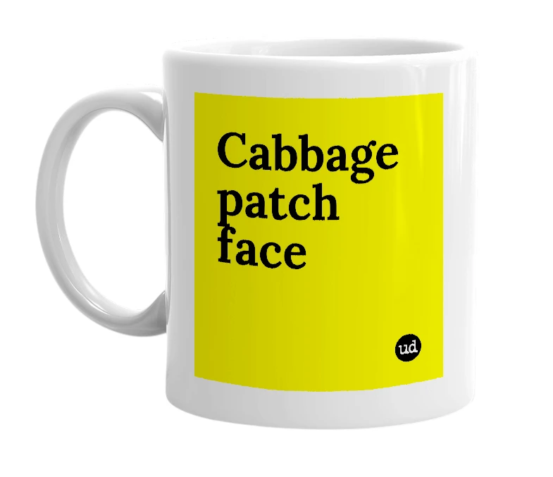 White mug with 'Cabbage patch face' in bold black letters