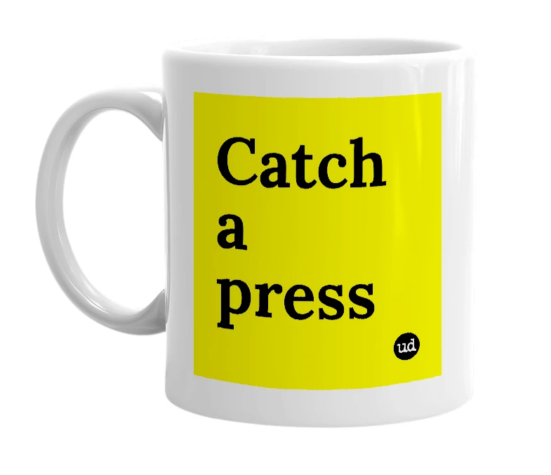 White mug with 'Catch a press' in bold black letters