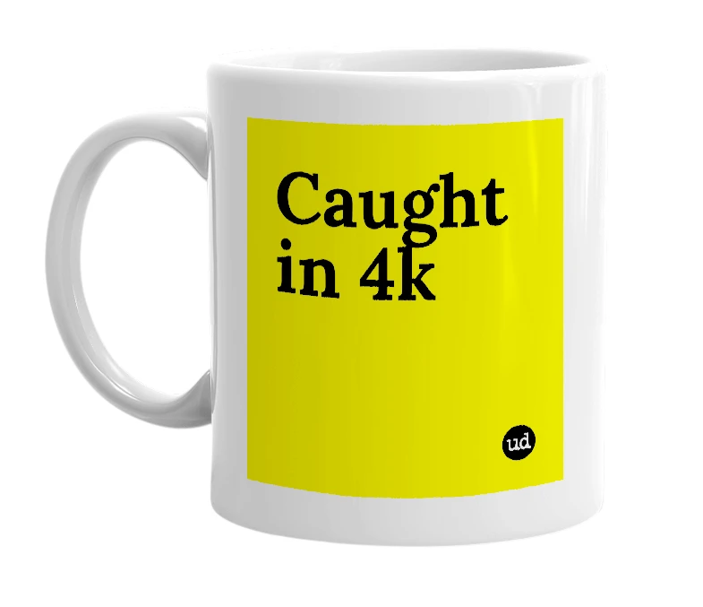 White mug with 'Caught in 4k' in bold black letters