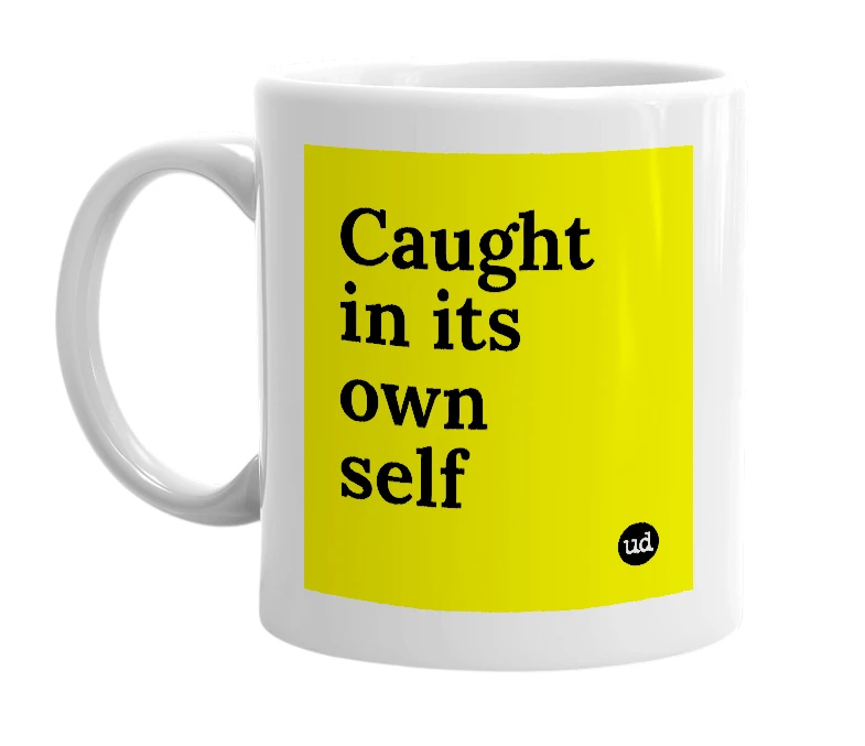 White mug with 'Caught in its own self' in bold black letters