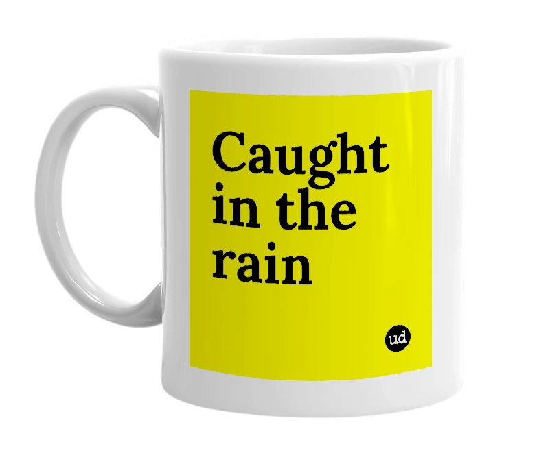 White mug with 'Caught in the rain' in bold black letters