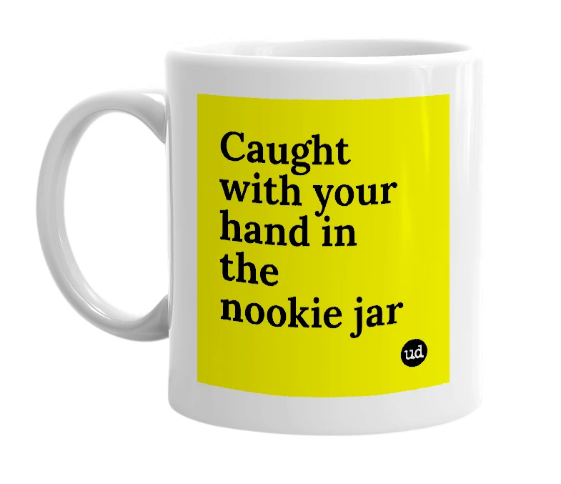White mug with 'Caught with your hand in the nookie jar' in bold black letters