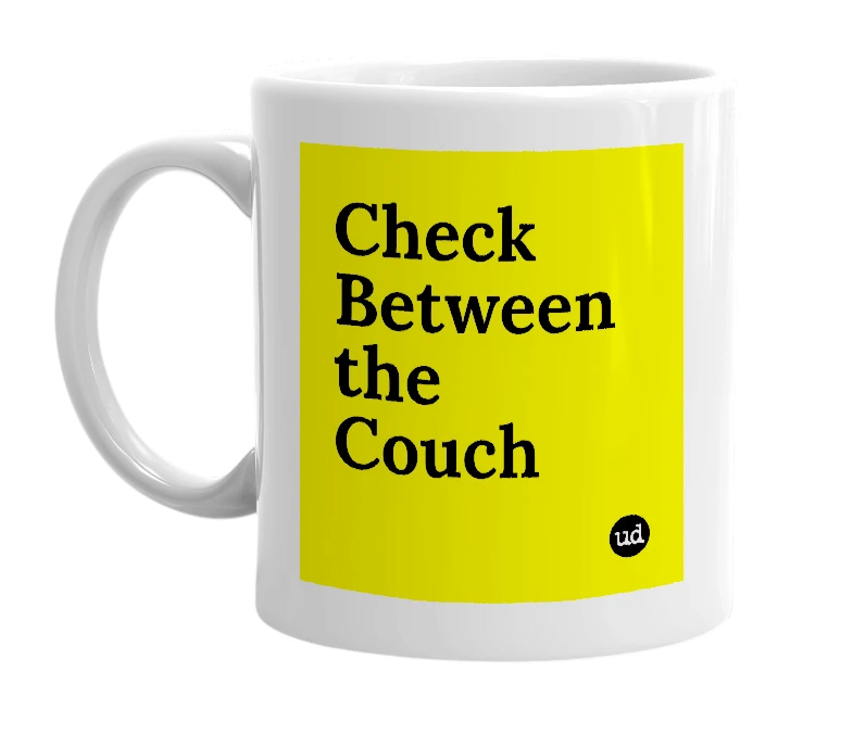 White mug with 'Check Between the Couch' in bold black letters