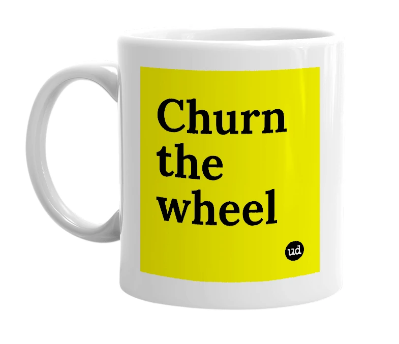 White mug with 'Churn the wheel' in bold black letters