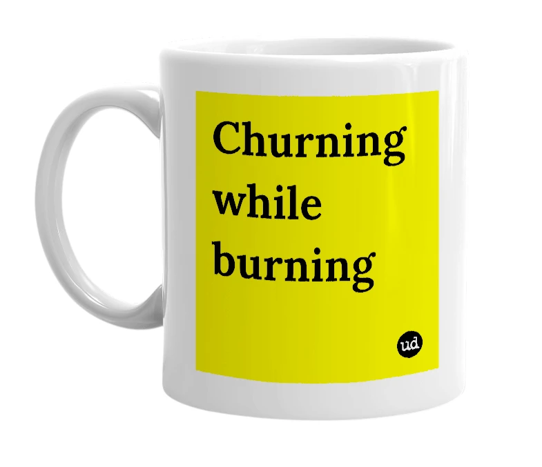 White mug with 'Churning while burning' in bold black letters