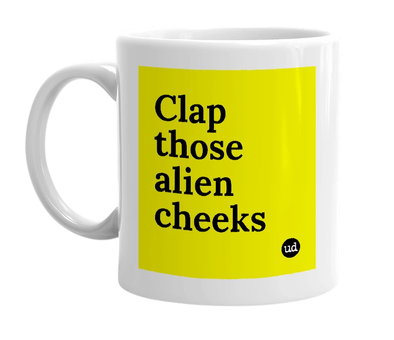 White mug with 'Clap those alien cheeks' in bold black letters
