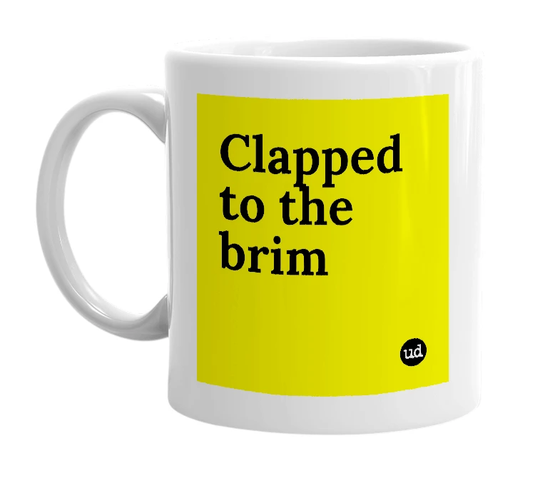 White mug with 'Clapped to the brim' in bold black letters