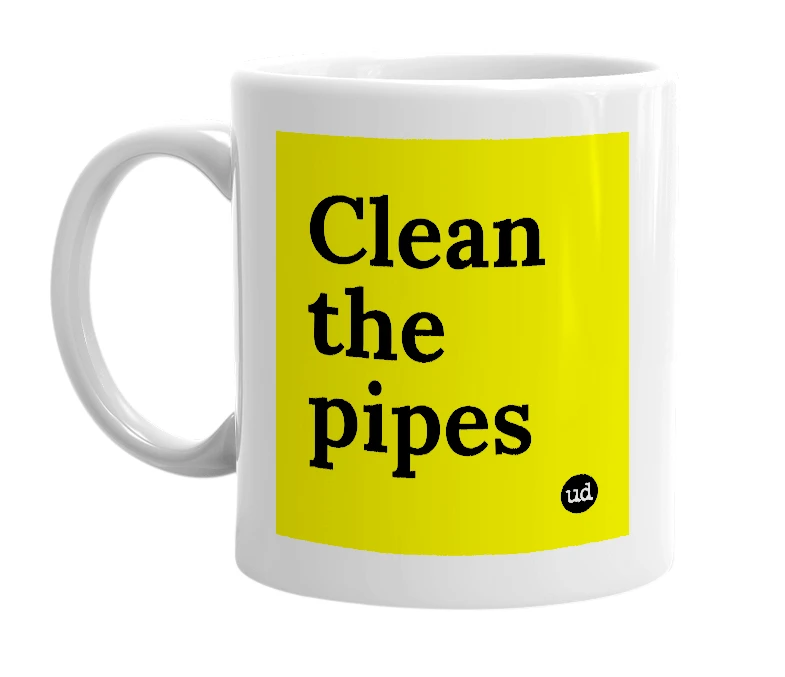 White mug with 'Clean the pipes' in bold black letters