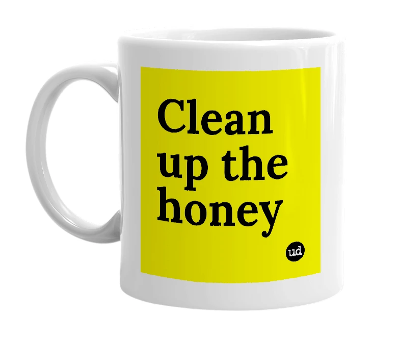 White mug with 'Clean up the honey' in bold black letters