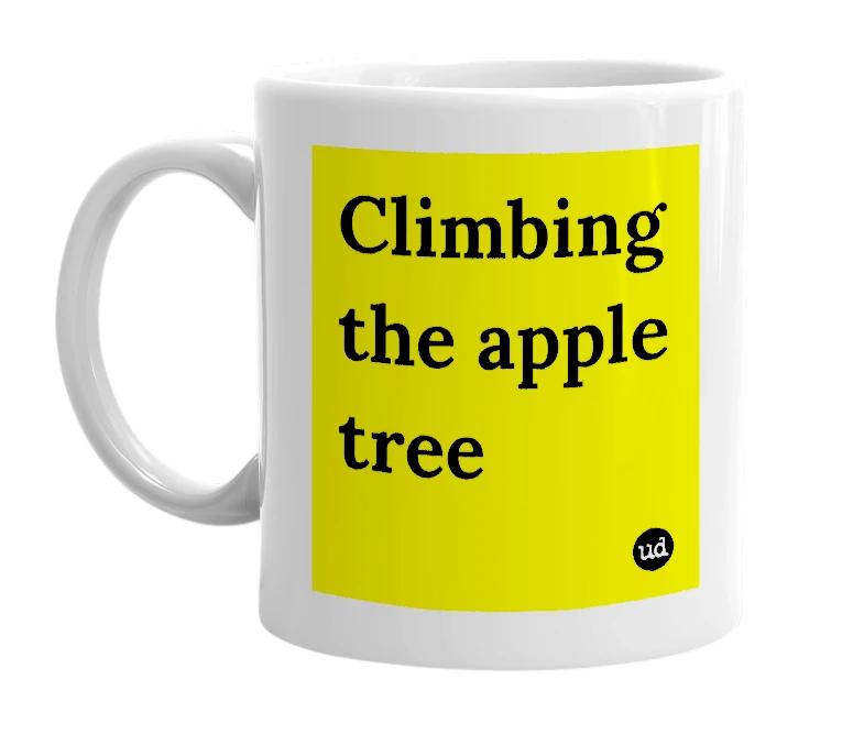 White mug with 'Climbing the apple tree' in bold black letters