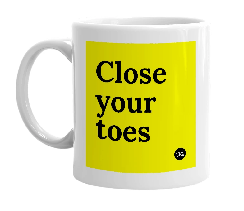 White mug with 'Close your toes' in bold black letters