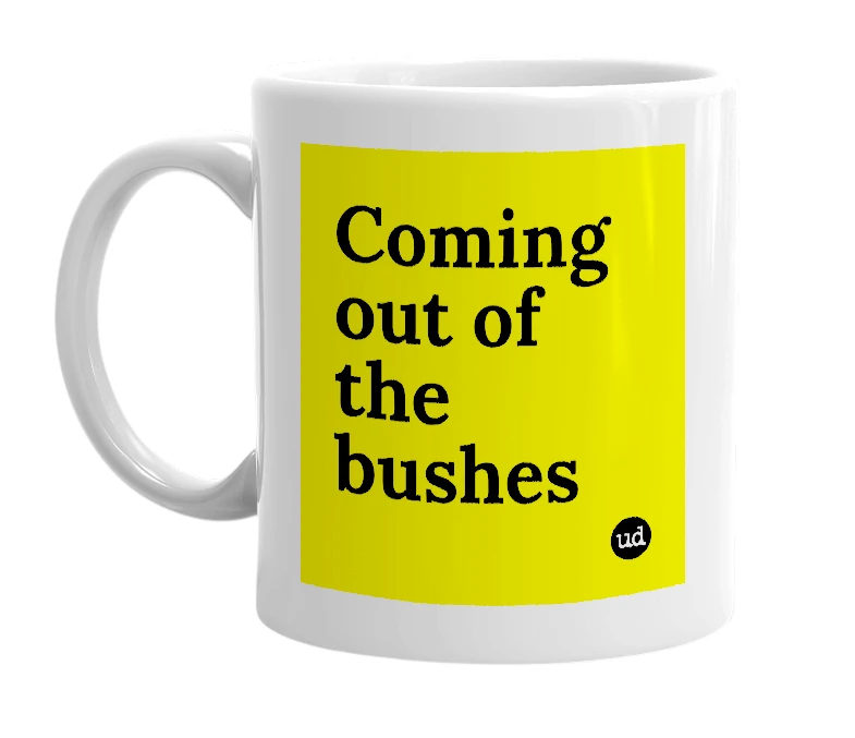White mug with 'Coming out of the bushes' in bold black letters