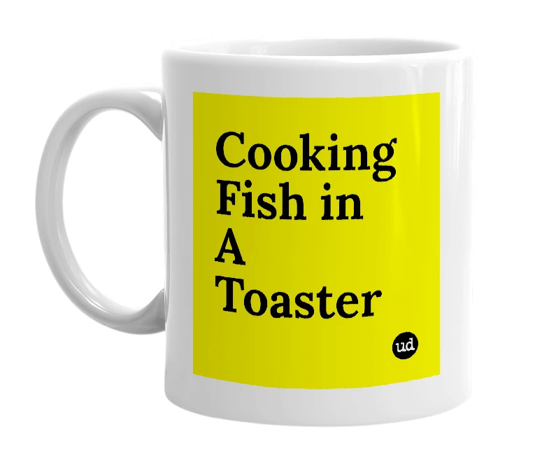 White mug with 'Cooking Fish in A Toaster' in bold black letters