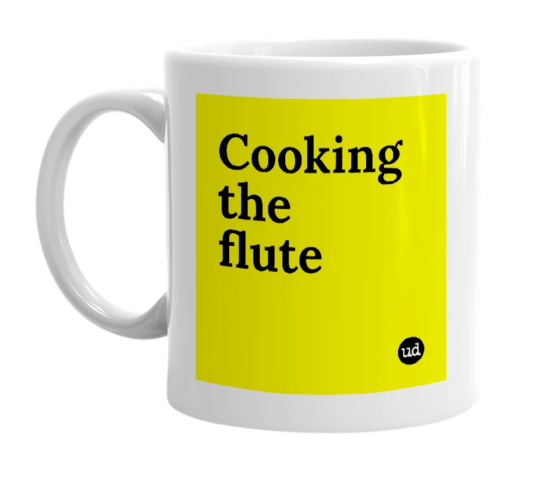 White mug with 'Cooking the flute' in bold black letters