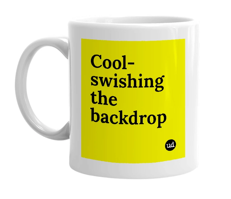 White mug with 'Cool-swishing the backdrop' in bold black letters