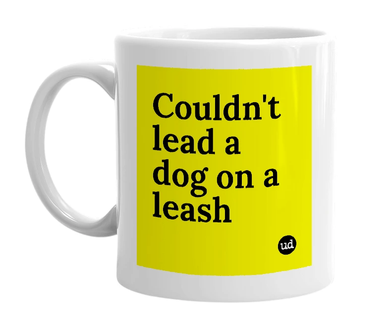 White mug with 'Couldn't lead a dog on a leash' in bold black letters