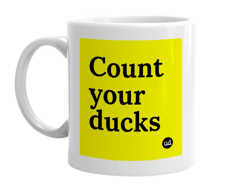 White mug with 'Count your ducks' in bold black letters