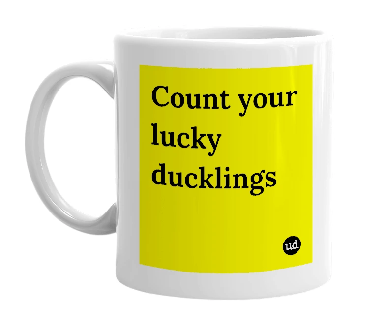 White mug with 'Count your lucky ducklings' in bold black letters