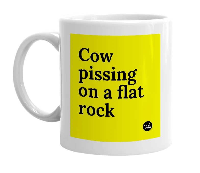 White mug with 'Cow pissing on a flat rock' in bold black letters